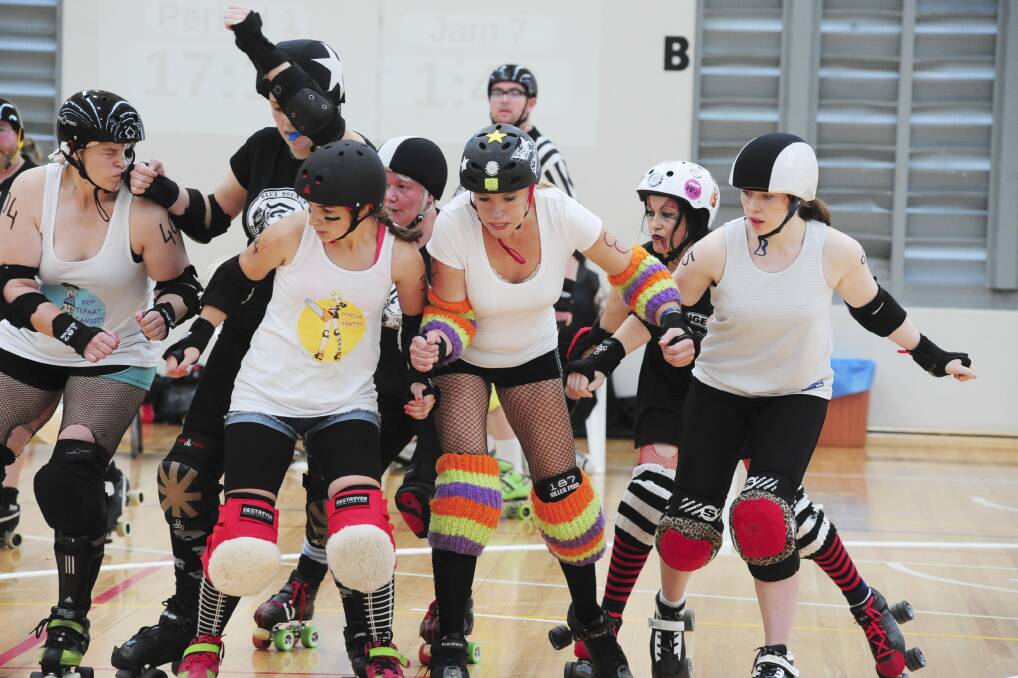 BRAWL ON WHEELS: The Dark Choc Bunnies and the White Choc Bilbies fight it out at the Easter Meltdown roller derby bout held at the PCYC. Photo: JUDE KEOGH