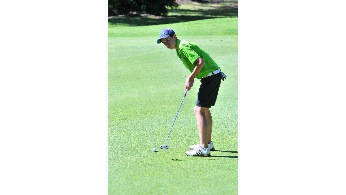 GOLF: Chris Moran putts in the Wentworth Junior Classic. Photo: JUDE KEOGH