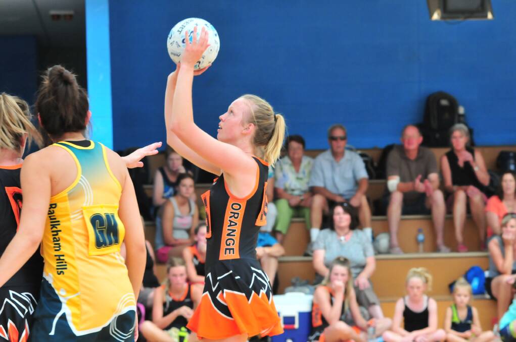 Orange A's Sophie Kloosterman shoots for goal against Baulkham Hills A on Saturday. Photo: JUDE KEOGH