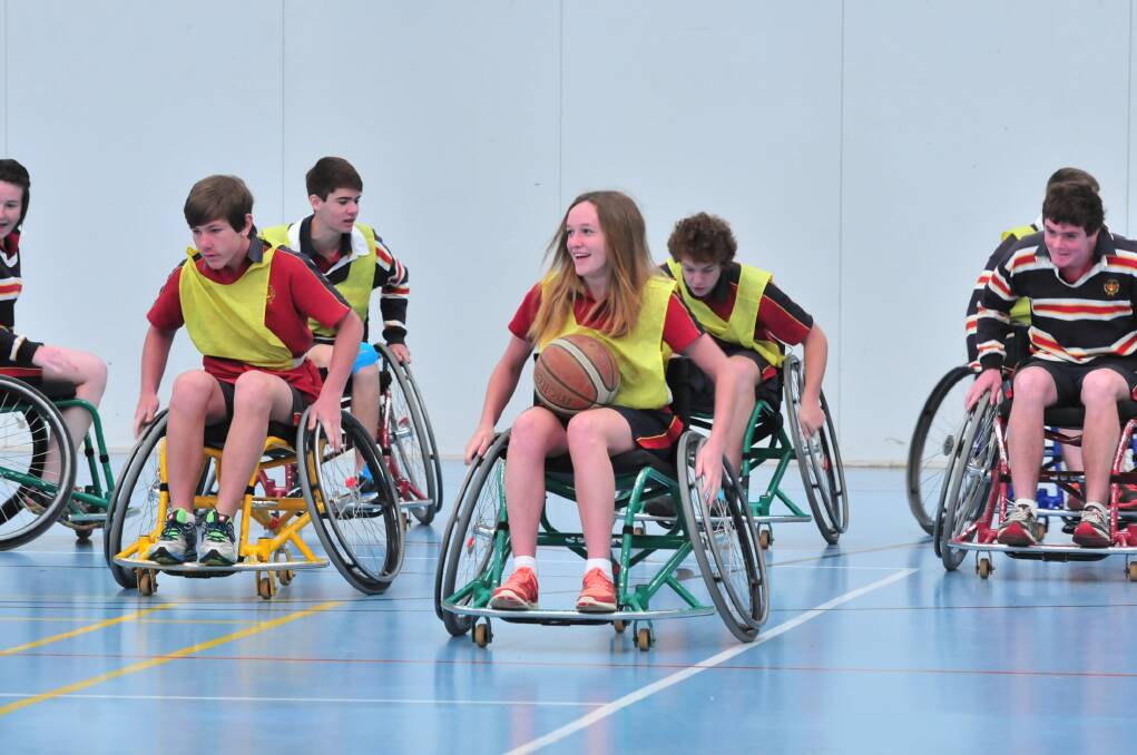 HOLDING COURT: James Sheahan Year 9 student April Rich on Wednesday took to the court for a game of wheelchair basketball, under the instruction of Wheelchair Sports NSW Roadshow instructor John Wade. Photo: JUDE KEOGH