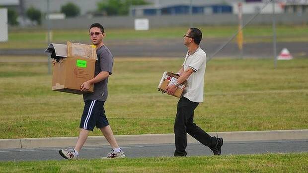 PACKING UP: Staff leave Brindabella Airlines after the announcement. Photo: KATHERINE GRIFFITHS