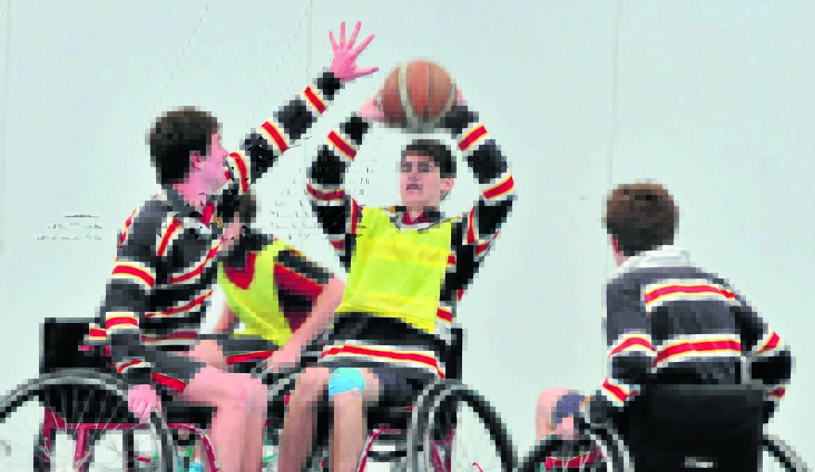 WHEEL WORLD: James Sheahan Catholic High School year 9 student Blake Mileto is stopped in his tracks in a game of wheelchair basketball. The game was part of the Wheelchair Sports Roadshow designed to raise awareness of spinal injuries.  Photos: JUDE KEOGH  1211wheelchair6