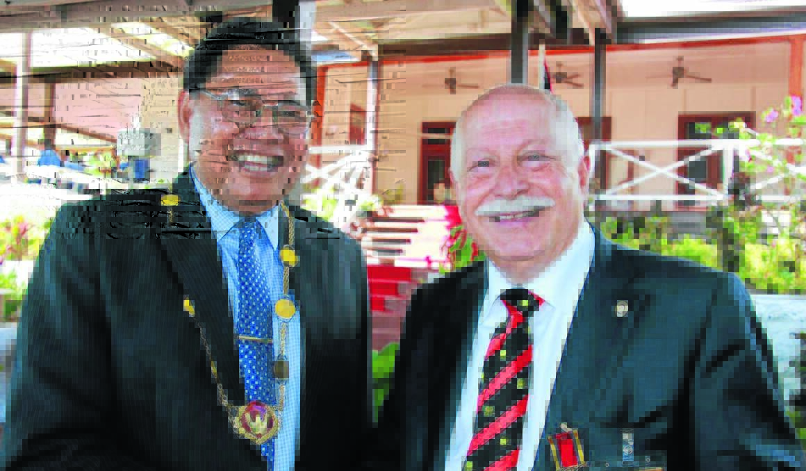 PNG HONOUR: Official secretary to the Governor-General Tipo Vuatha (above) congratulates Cr Chris Gryllis for receiving the Logohu Medal (LM).    