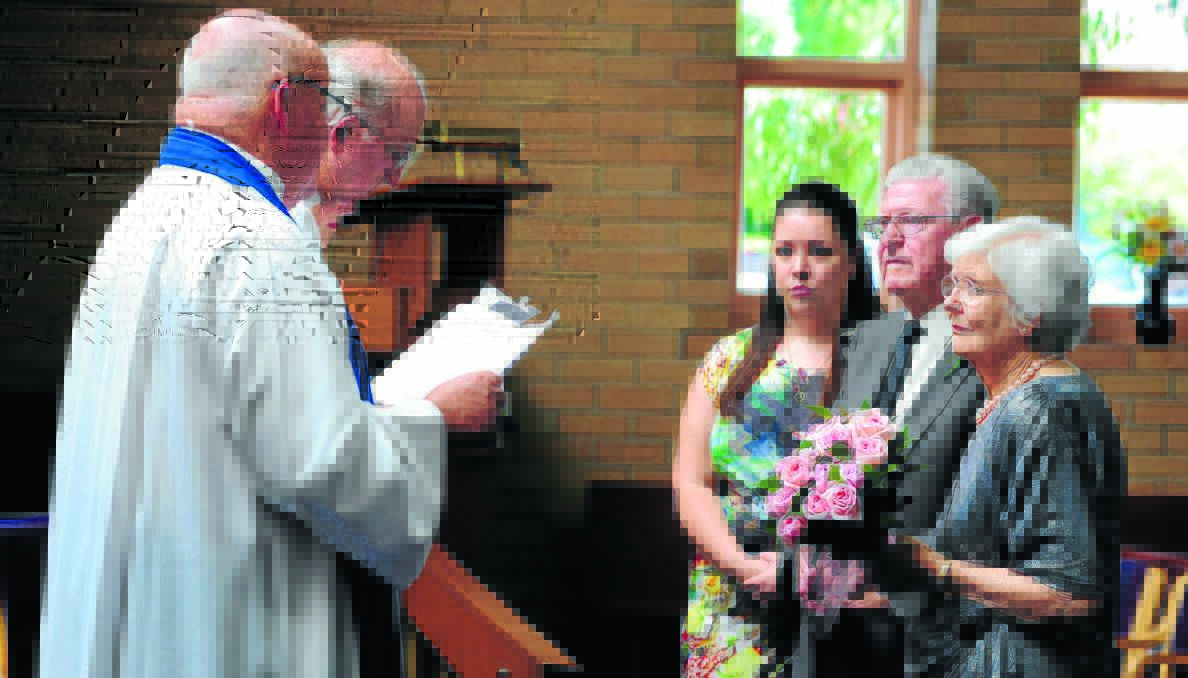 LOVELY SERVICE: Reverend Gary Neville officiates at the wedding of Reverend Alan McAnulty and Rosemary Brown as Stacey Brewer looks on. Photo: STEVE GOSCH