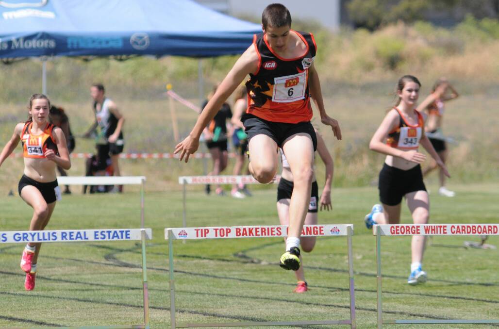 ON TRACK: Orange's Connor Barlow tackles the hurdles. Photo: STEVE GOSCH
