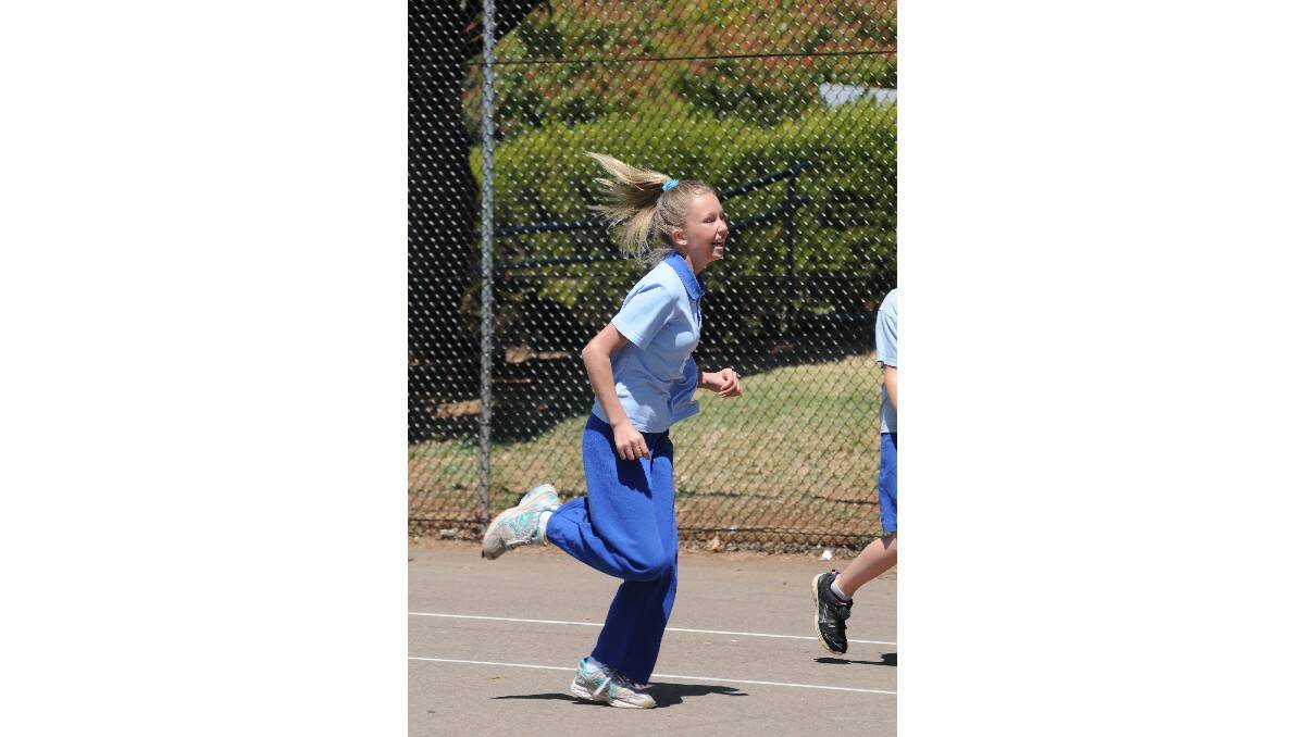 RUNNING GIRL: Manildra Public School's Crystal Xeureb in the thick of the game action. Photo: STEVE GOSCH