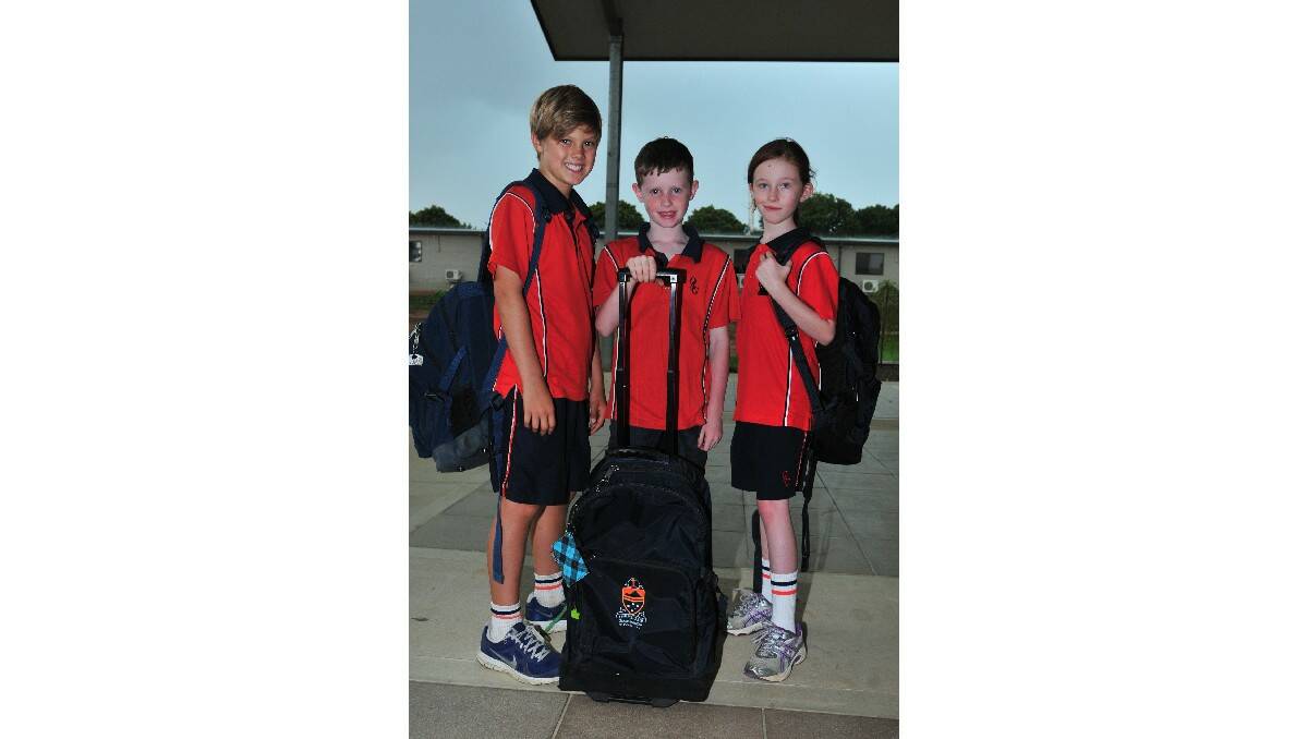 WEIGHT OF THE WORLD: Orange Anglican Grammar students Cooper, Charlie and Louisa demostrate the different bags available at the school.  Photo: LUKE SCHUYLER        0201lsgrammar1
