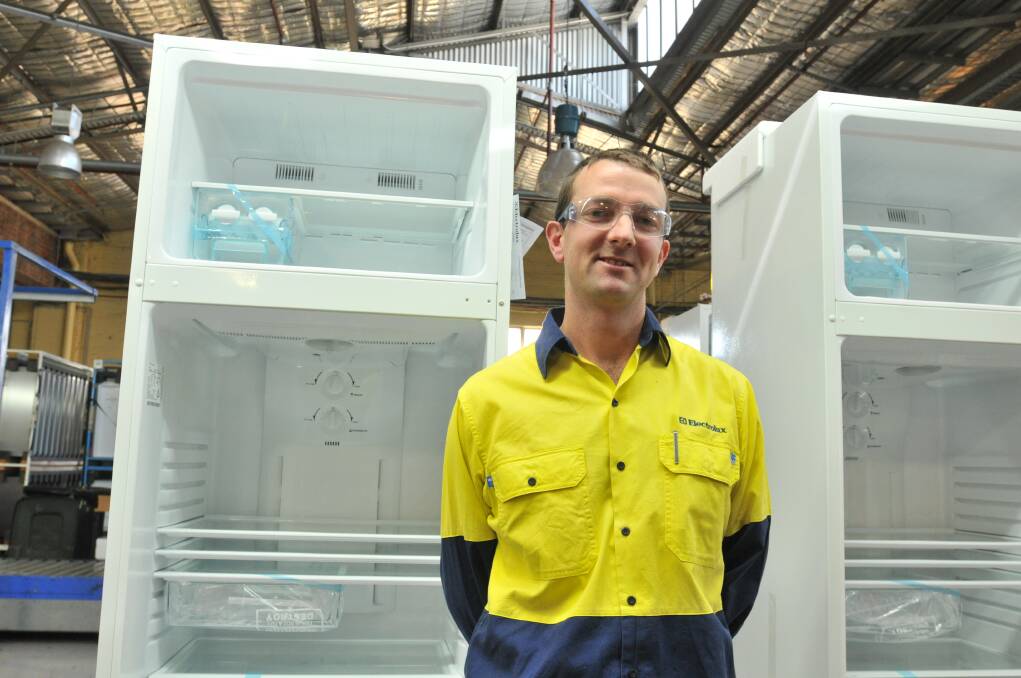 PRIDE: Production manager Mathew Vickery with the 420-litre top mount fridge, the most popular fridge ever  produced at Electrolux.
Photo: JUDE KEOGH 0723electrolux6