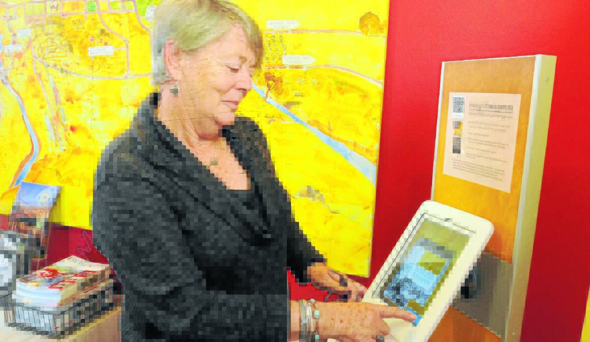 HAPPY TRAILS: Adelaide visitor Maurene McEwan tests the new Gold Trails website at the Orange Visitor Information Centre.   Photo: Steve Gosch 0529ipad1