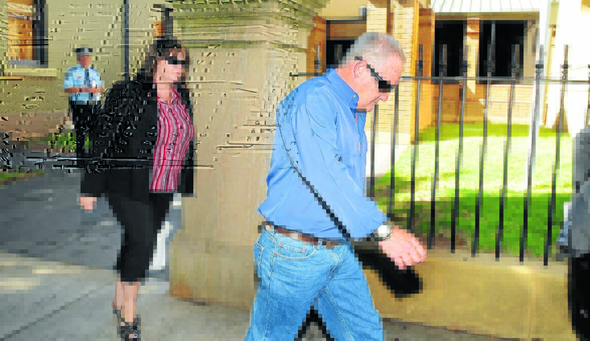 SAD CASE: After spending the night at the police station with her son, the mother of a man accused of critically injuring another man with a punch to the head leaves Orange Local Court yesterday with her partner following a bail hearing. Photo: STEVE GOSCH              0127sgcourt2