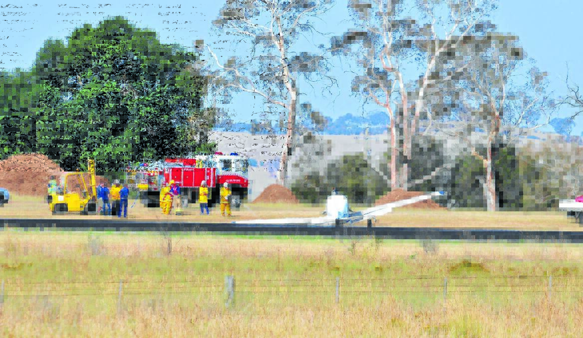  OVERSHOT: Emergency crews determine the seriousness of a plane crash at Orange Airport. Photo: JUDE KEOGH 0115plane4   