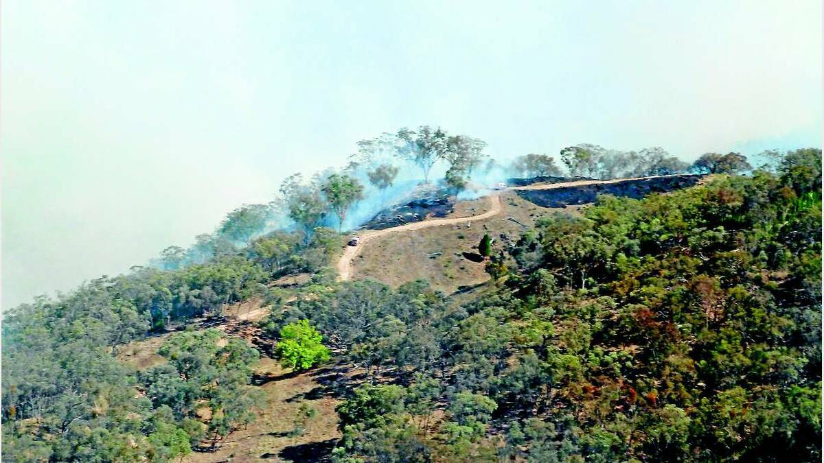 Firefighters work to contain an out-of-control 75-hectare fire at Long Point Crossing near Mullion Creek north of Orange. Photo: NSW Rural Fire Service. 