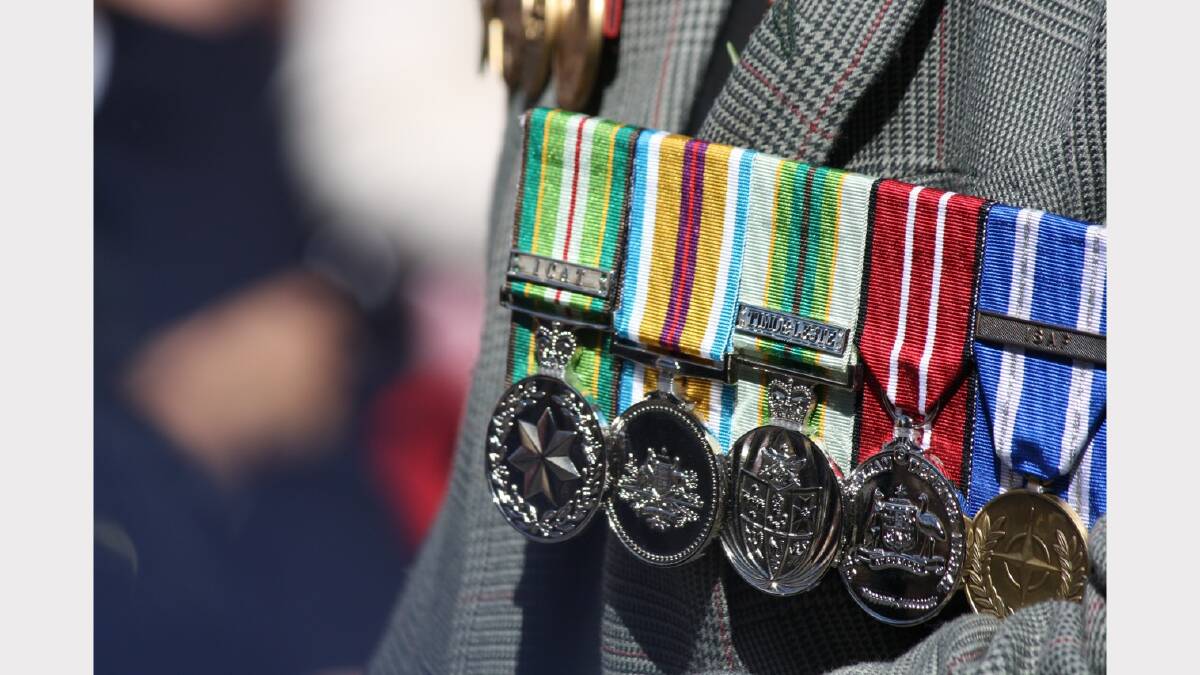 Medals, carefully polished and pinned to proud chests.