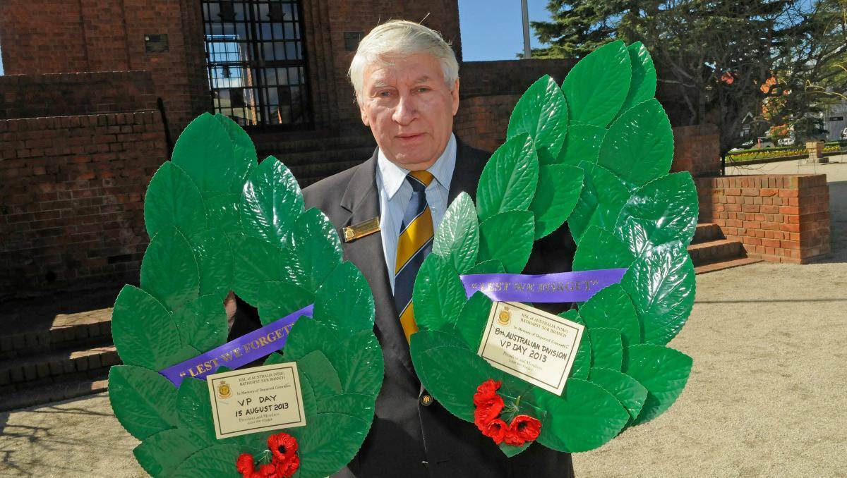 Bathurst RSL sub branch president Denis Chamberlain with two of the wreaths that were laid at the War memorial Carillon on Thursday morning as part of the region's VP Day commemoration.
