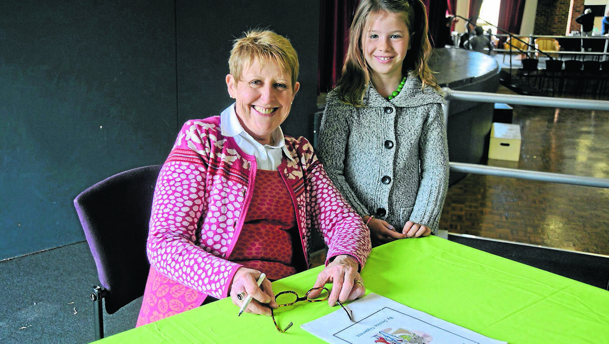 MUDGEE: Mem Fox meets fellow author, seven-year-old Jessica Nipperess at the Mudgee Reader’s Festival. Jessica’s book A Knight’s Quest is on the table in front of Mem.