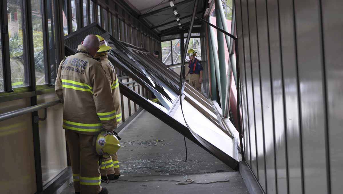 LITHGOW: Fire and rescue members were called after portion of the enclosed pedestrian ramp at Lithgow railway interchange suffered extensive damage at the height of the wild windstorm. Photo: Carolyn Piggot.