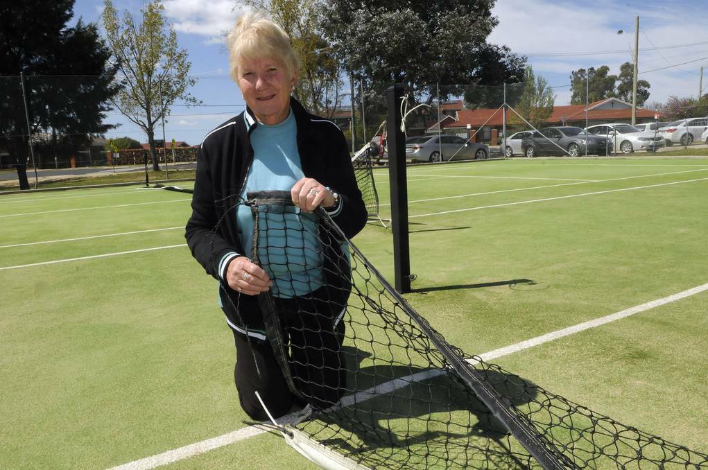 BATHURST: Elaine Webb from the Macquarie View Tennis Club at the Mitre Street courts yesterday after discovering vandals had forced their way into the facility and cut up their nets. Photo: PHILL MURRAY