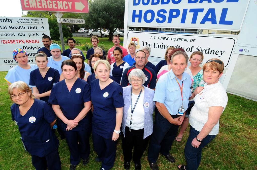 DUBBO: NSW Nurses and Midwives Association Dubbo Hospital branch members (front) Julie Anderson, Natalie Magill, Amber Diamond, Lorraine Keher, Richard Bolton, Cherie White and their colleagues gather to urge hospital management to fill vacancies in the emergency department. Photo: LOUISE DONGES.