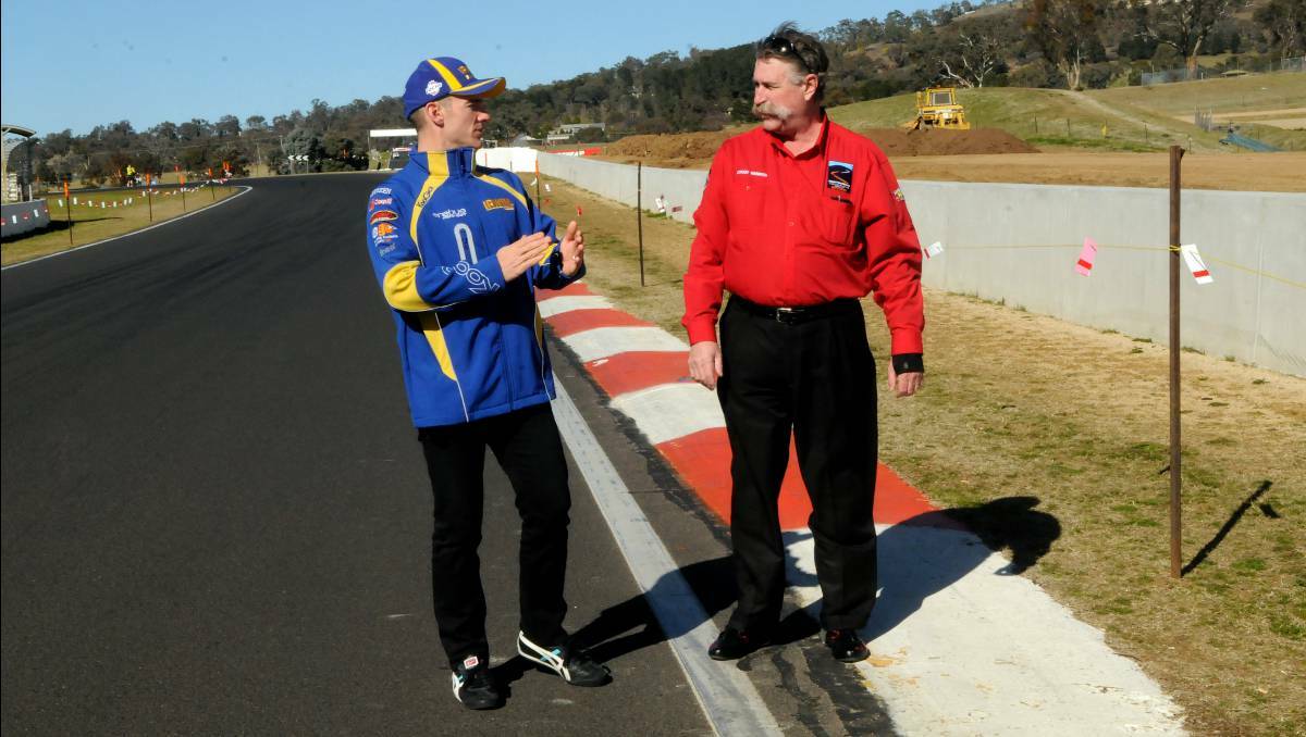 BATHURST: V8 Supercar driver Lee Holdsworth and Mount Panorama circuit manager Mark Rayner inspect the changes to The Chase which are aimed at making the track safer. Photo: Phill Murray.