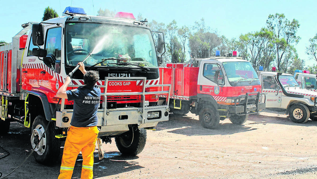 Cooks Gap RFS Brigade member John McGovern cleans one of their trucks at the Open Day and Equipment Day on Saturday.