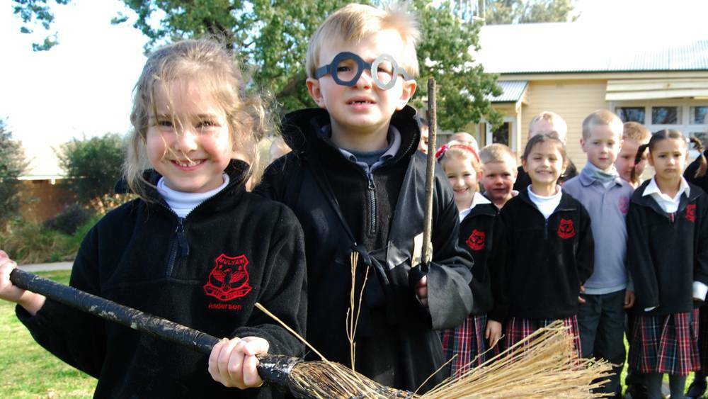 COWRA: Mulyan Public School students Cailee Anderson and Digby McGregor pose as Hermione Granger and Harry Potter watched by fellow kinders. 