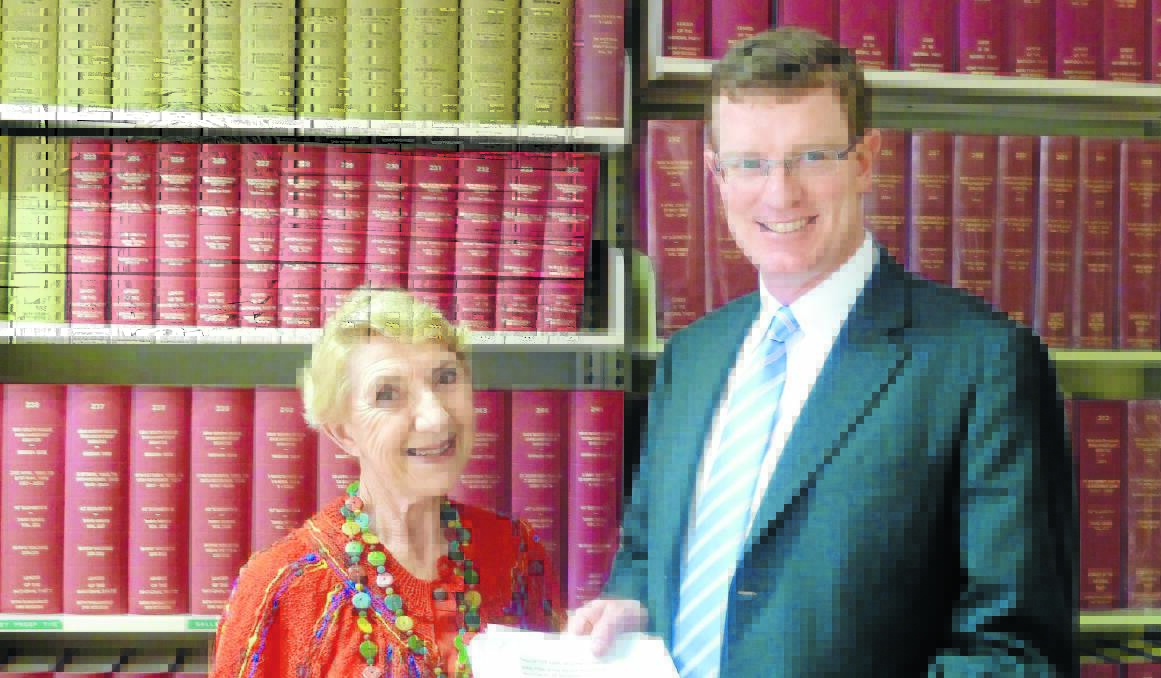 WRITE STUFF: Palliative care specialist Dr Yvonne McMaster hands member for Orange Andrew Gee the signatures of residents of his electorate on a petition calling for more funding to allow the terminally ill to die at home. 