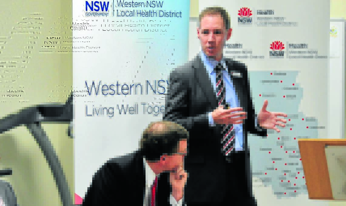 ALL EARS: Member for Orange Andrew Gee listens intently to chief executive of Western NSW Local Health District Scott McLachlan.