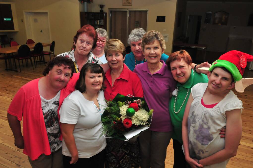 GOODBYE TO FRIENDS: Margaret Sutton (holding flowers is farewelled as teacher of the senior citizens line dancing class. She was joined by, from left, Jenny Oxley, Pip Jackson, Janet Jackson Helen Townsend, Hollie Hennessey and (back) Carmel Bouffler, Barb Russell and Heather Oxley. Photo JUDE KEOGH                                                                                                                                                                                                                     1219linedance1