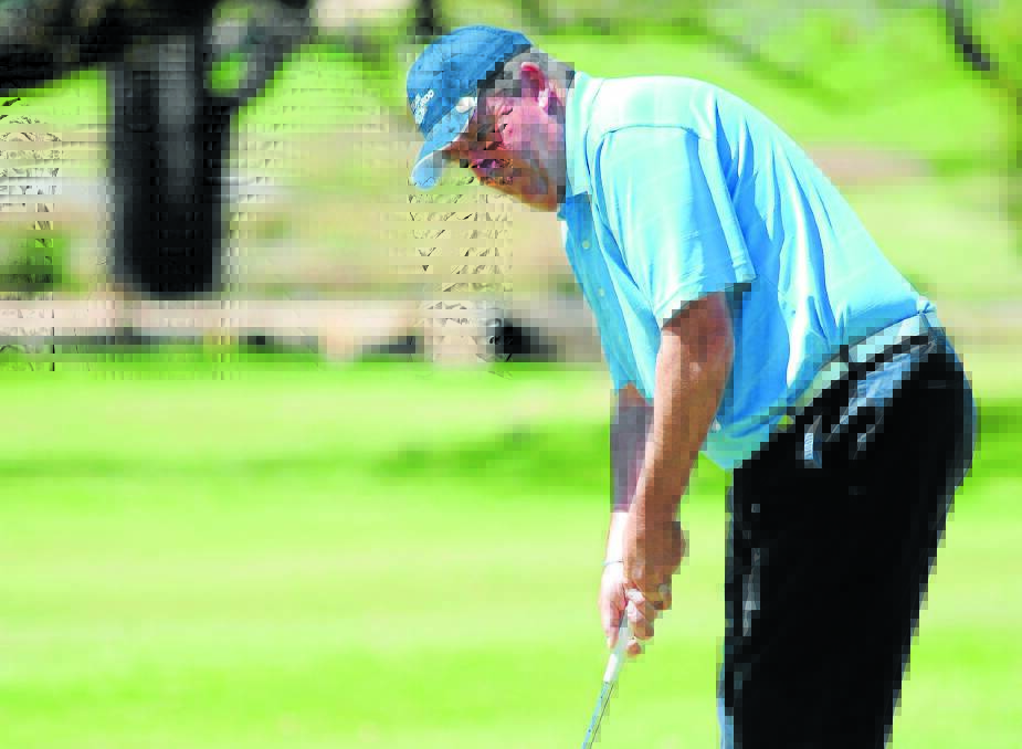IN FRONT: Robert Payne watches his putt at Orange Ex-Services’ Country Club yesterday. Photo: STEVE GOSCH 						     1001sggolf1