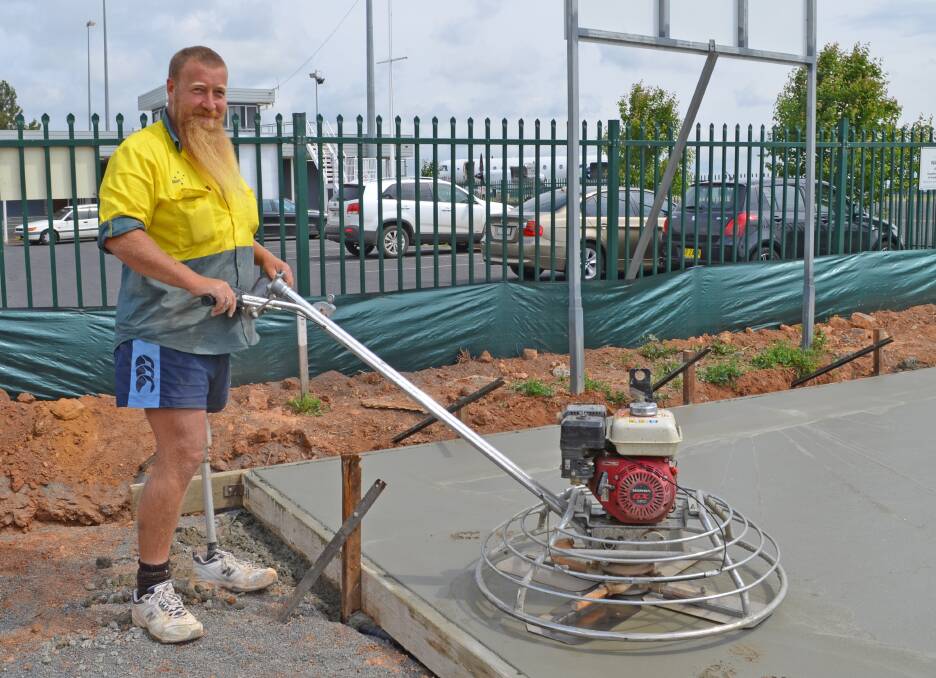 FOUNDATIONS: Orange firm Matt B Concreting owner Matt Bingham working on the concrete slab at Orange Airport for the new temporary terminal building. 
