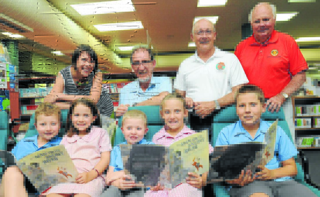GET READING:  Illustrator Freya Blackwood, librarian Peter Douglass and Rotary Club of Orange's Len Banks and Malcolm Campbell (back), with students Elliot McDonell, Millie Banks, Joey McDonell, Sophie Banks and Ryan Banks got busy learning about one of Australia's greatest bush poets yesterday. Photo: STEVE GOSCH 0203sgbanjo