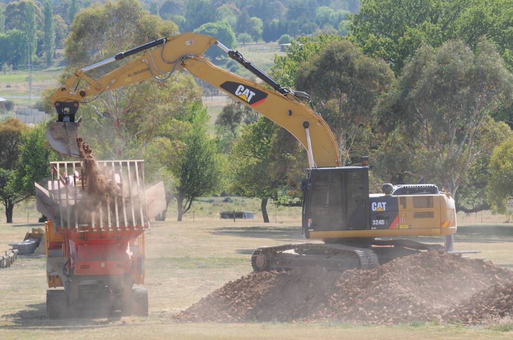 DIRTY WORK: Work got underway to crush bricks at Banjo Paterson Park to form a path on Monday.