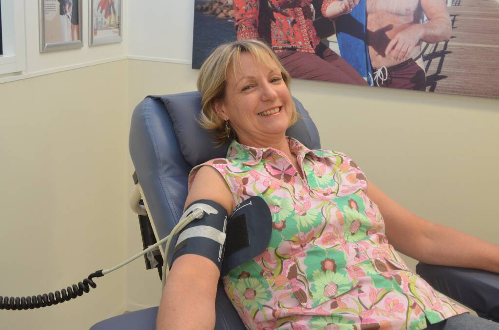 BRAVE: Christine Hawke pumps up her veins in preparation for her first blood donation. 