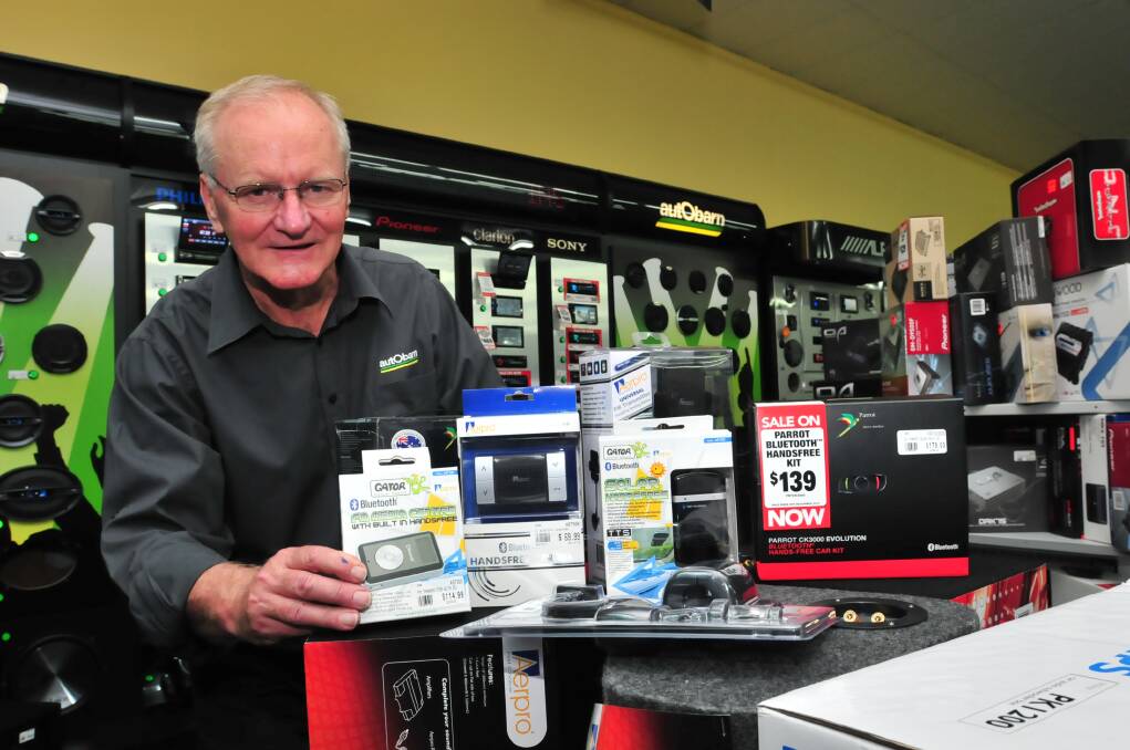RUNNING OFF THE SHELVES: Peter Cheney said staff have been kept busy keeping up with the demand for hands-free phone car kits, after tougher penalties imposed by NSW police for using a mobile phone while driving.  Photo: JUDE KEOGH                                                                                             1130carkit 
