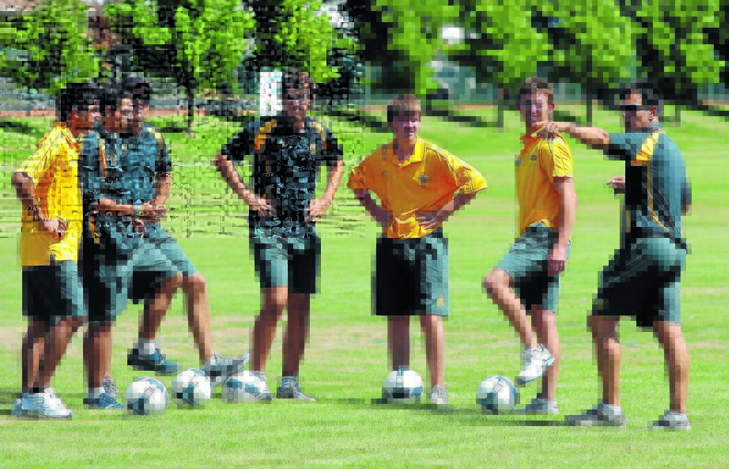DISAPPOINTED: Deaf Football Australian coach Rob Stanton, right, gives his players instructions during this year’s visit to Orange. Unfortunately the side will not return in 2014 but have not ruled out a return in the future.  Photo: STEVE GOSCH  