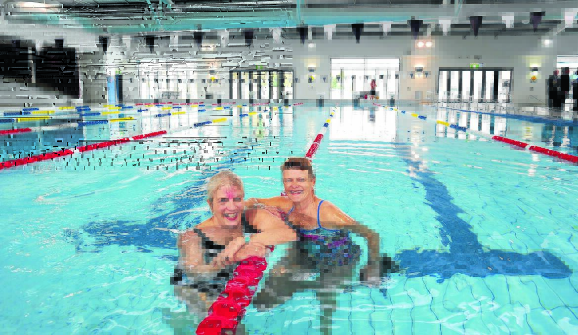 DIVE IN: Swimfit members Jenny Hazelton and Gay Stone were the first swimmers to try out the new 25-metre pool. Photo: STEVE GOSCH   0831sgpool1