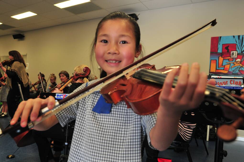 BUDDING MAESTRO: Nine-year-old Cathy Miao received the Clair Humphrys scholarship which will give her individual tuition on the violin. Photo: LUKE SCHUYLER                                                      1120lsscholar3