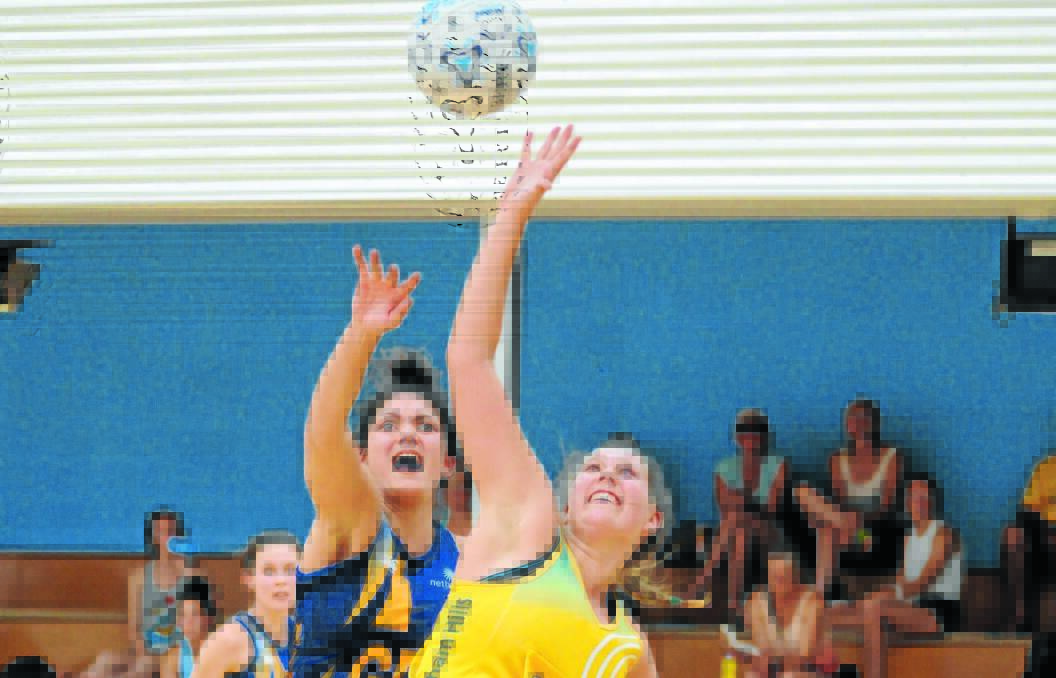 HIGH BALL: Baulkham Hills shooter Olivia Doyle (right) is pressured by ACT 21s goal defence Keely Rodrigo during Sunday's HeartKids Cup grand final. Photo: STEVE GOSCH 0202sgnet4