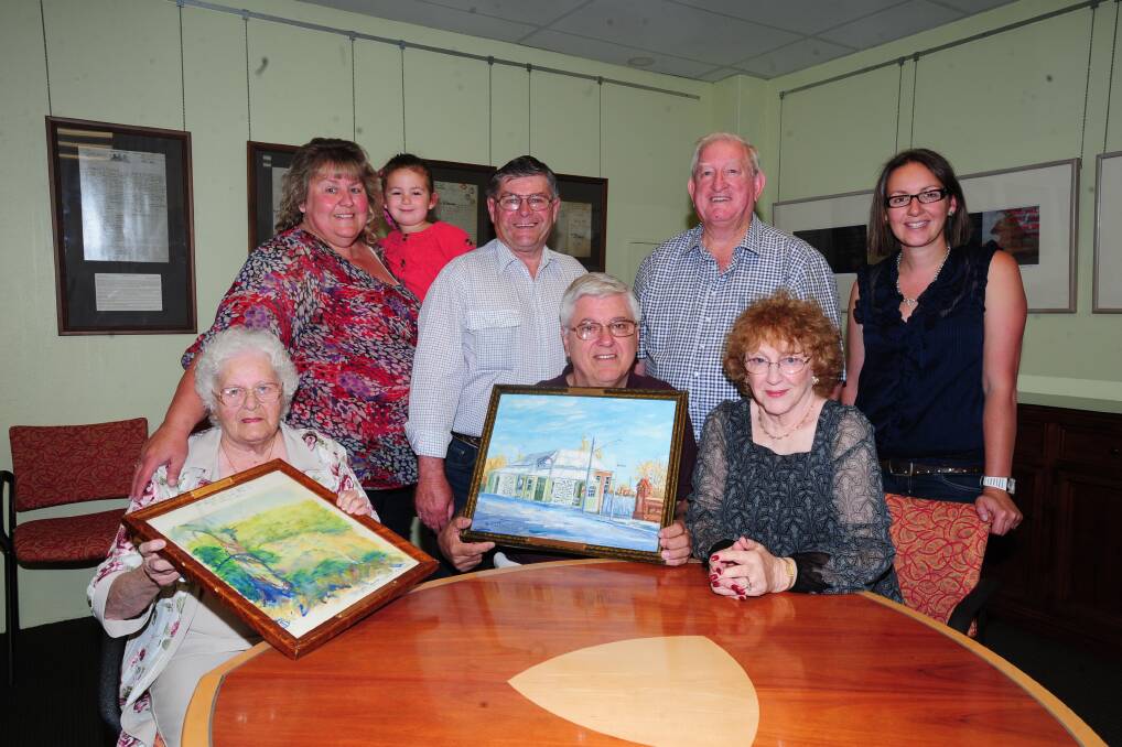 COMING HOME: Orange-based artist Martin Coyte’s painting have returned to Orange after hanging in the United States for many years. From left Olga Mendham, Ed and Sandy Bonczek from the United States and (back) Kerrie Taber, Abby Gregory, 3, Kevin Mendham, mayor of Orange John Davis, and Rebeccas Gregory. Photo: LUKE SCHYLER                                                                                                   1113lspicture 