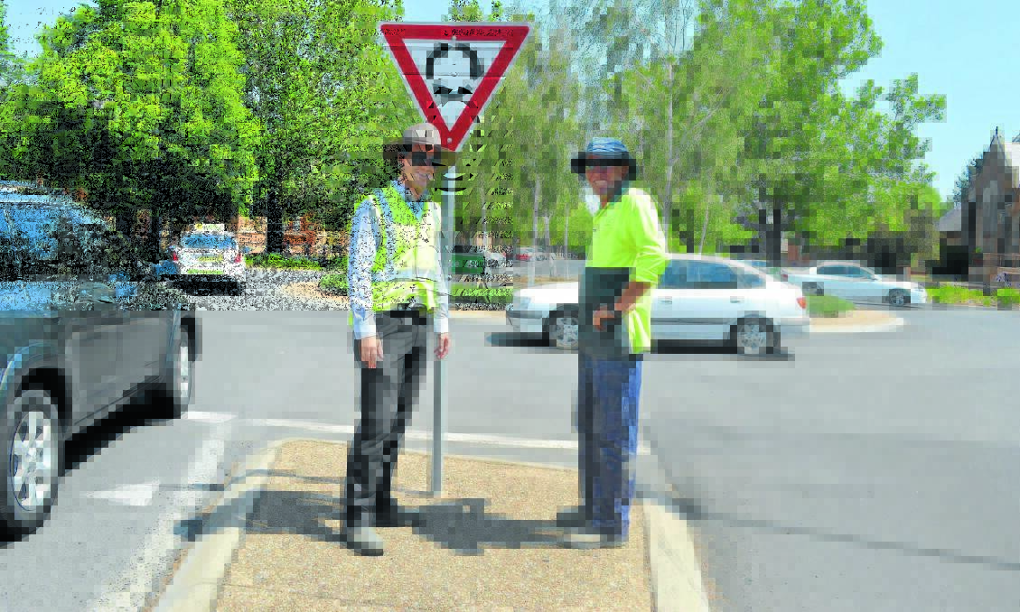 WORK IN PROGRESS: Works engineer Josh Devitt and acting supervisor Greg Carter inspect the Kite and Sale streets roundabout ahead of the intersection’s closure for roadworks on Tuesday. Photo: CLARE COLLEY                                                                                                                                                                          0113ccroundabout1