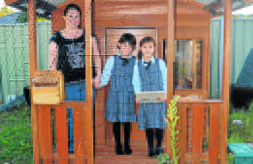HELPING HAND: Louise Rosser doesn’t know what she would do if the small school she sends her children Sophie Eleftheriou, 10, and Emily Eleftheriou, 7, to was to close. Photo: NADINE MORTON                    0501nmndis4 