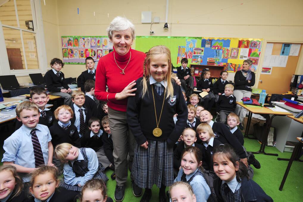 GOLDEN OPPORTUNITY AT CLERGATE: Kate Smith and fellow Clergate students were thrilled to hear about Olympic champion swimmer Gail Yeo’s experience of winning gold at the Munich Olympics. Photo: JUDE KEOGH         0727clergate6 
