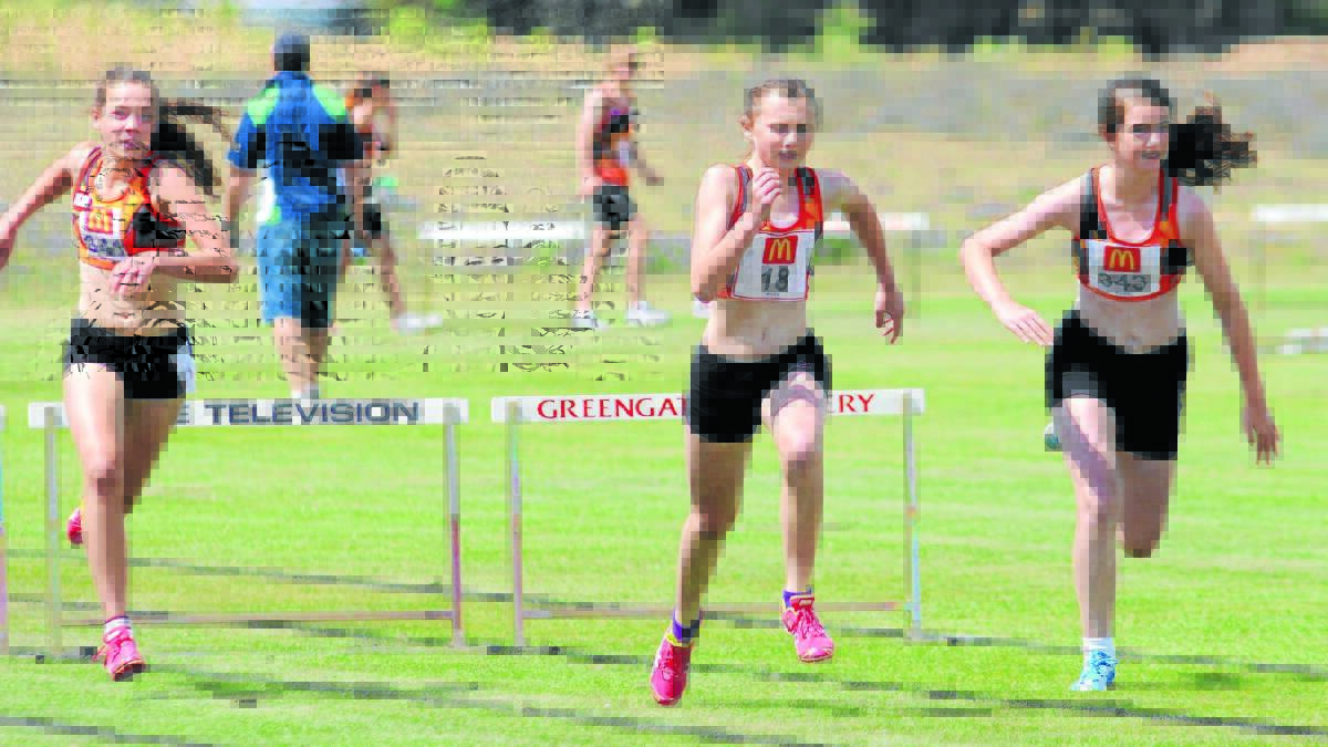 HOME TURF: Orange's Millie Lenehan, Brie Annis-Brown and Georgia Poole tackle the Waratahs turf track in November. Waratahs was floated as a location for a synthetic track in Orange. Photo: STEVE GOSCH                                                                                                                                         1120sgathletics5