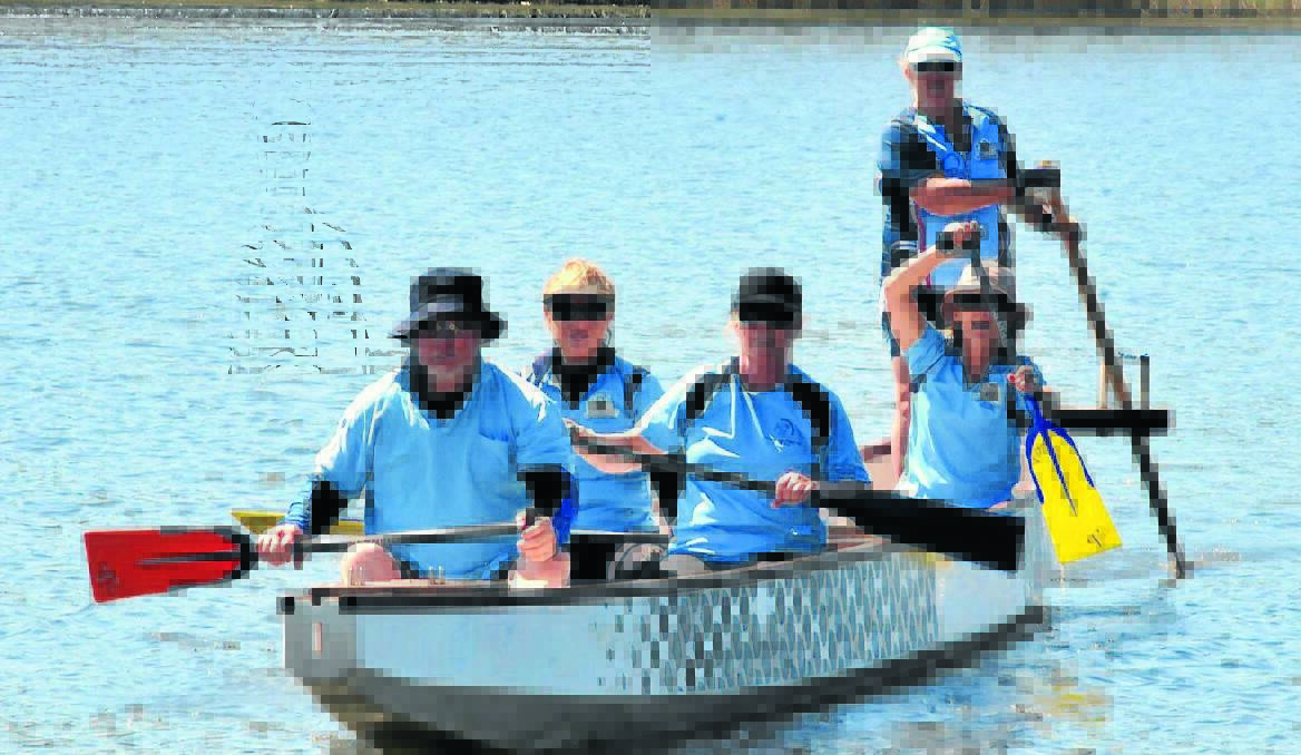 KEEPING COOL: Dragons Abreast Orange paddlers John Tranter, Louise Linke, Phiz Cogswell, Vicki Gransden, Deb Clarke hit the water to keep cool during Saturday's scorching weather.  Photo: JUDE KEOGH 0118weather2