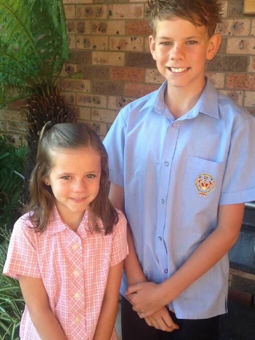Ben Norris' first day in year seven at James Sheahan Catholic High School with his little sister Hayley starting year two at Catherine McAuley Catholic Primary School. Photo: BEN NORRIS