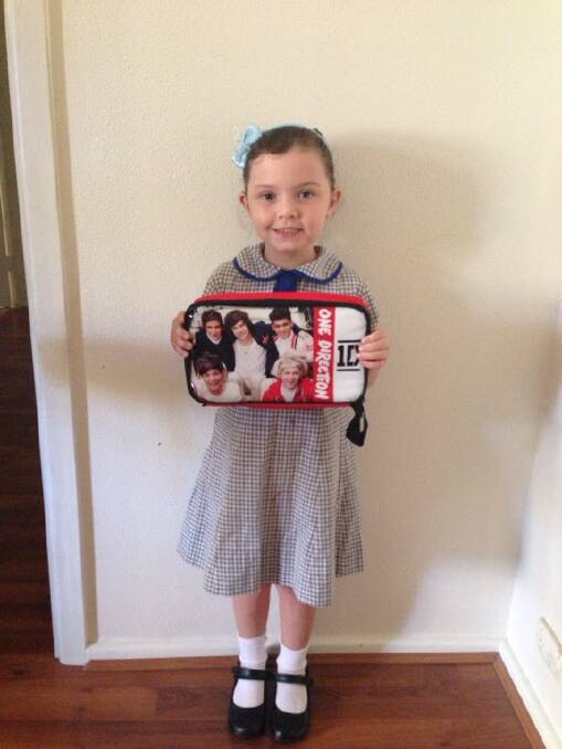 Mia Seymour excited about using her new 1D lunch box on her first day of Year 1. Photo: JADE HAYES