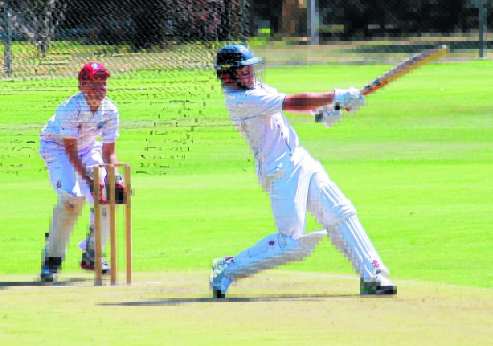 SO CLOSE: Mitchell batsman Michael Hannelly hits out on his way to 96 against Illawarra yesterday. Photo: MELISE COLEMAN  0114mccricket9