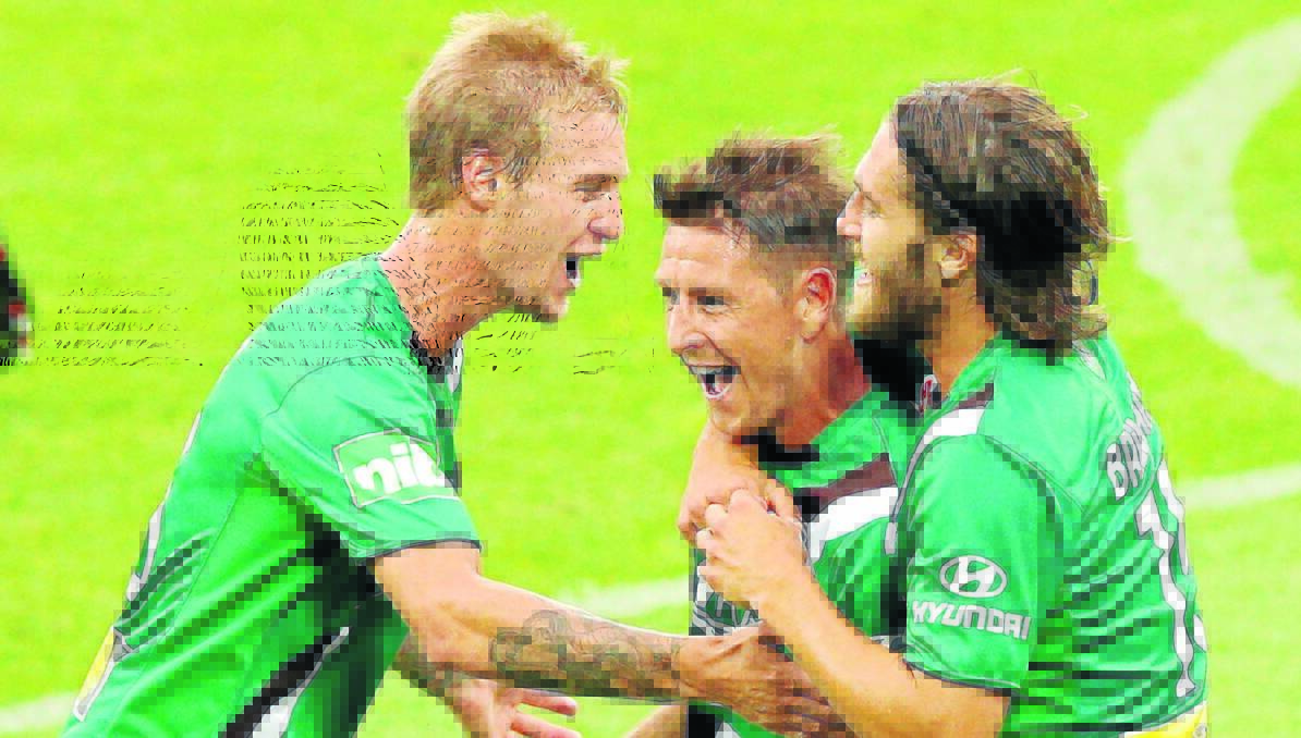 YEAH: Nathan Burns (centre) celebrates his goal with Jacob Pepper, (left) and Joshua Brillante during the round nine A-League match against the Melbourne Victory. Photo by Michael Dodge/Getty Images