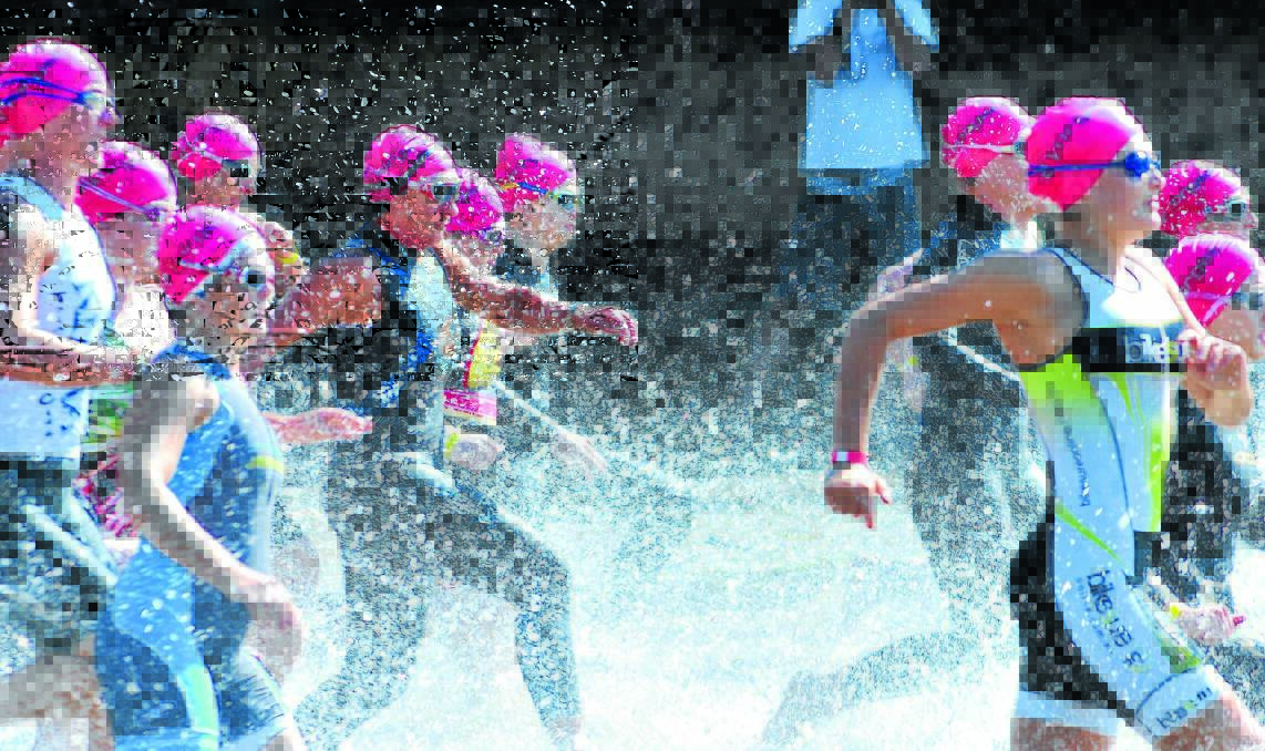 MAKING A SPLASH: The ladies hit the water for the sprint event in the Orange Toyota TriOrange Triathlon Festival at Lake Canobolas on Saturday. Photo: JUDE KEOGH 0201tri1