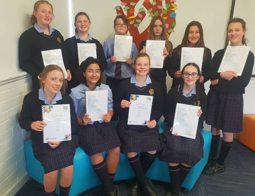 THE STORYTELLERS: James Sheahan Catholic High School year 7 students, front, Lily Barnes, Erin Whiteley, Eloise Milne, Holly Finlay, and back, Xanthe Huxtable, Jillian Smith, Christopher Gott, Billie Mills, Bianca De Swardt, Arabella Evans, wrote a book last week. Photo: SUPPLIED